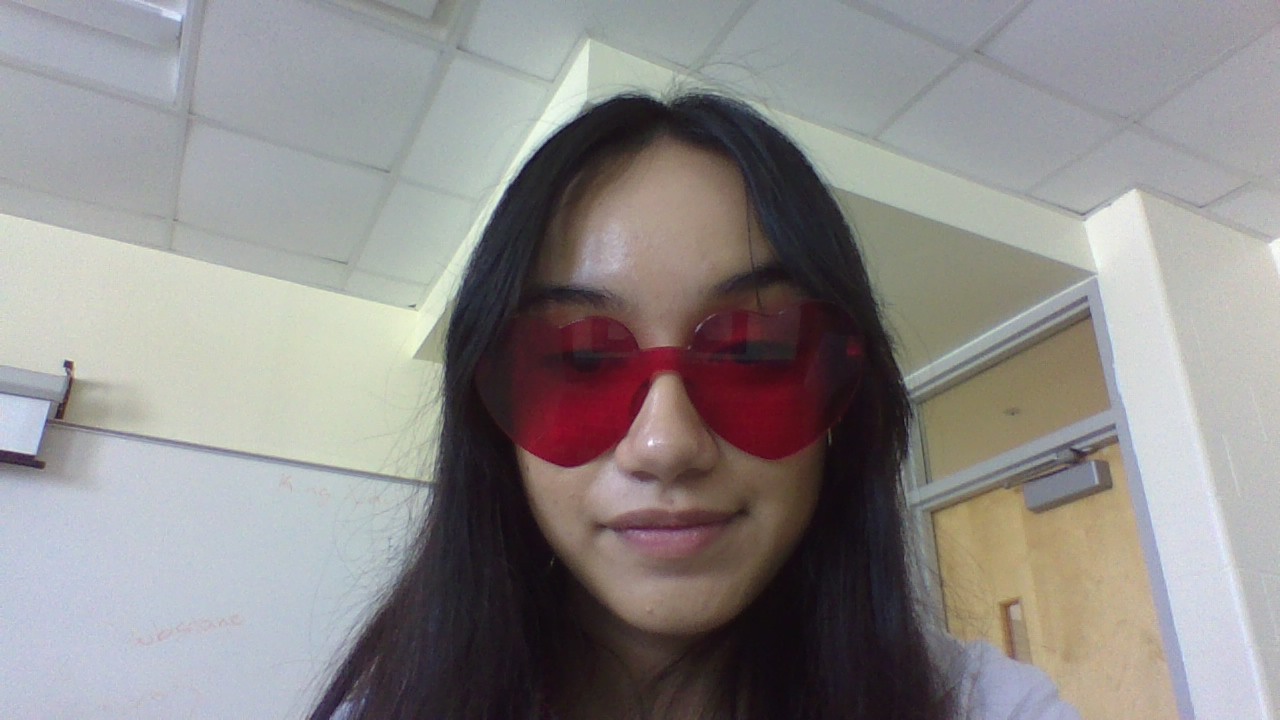 Jasmine wearing heart-shaped sunglasses in honor of Valentine's Day